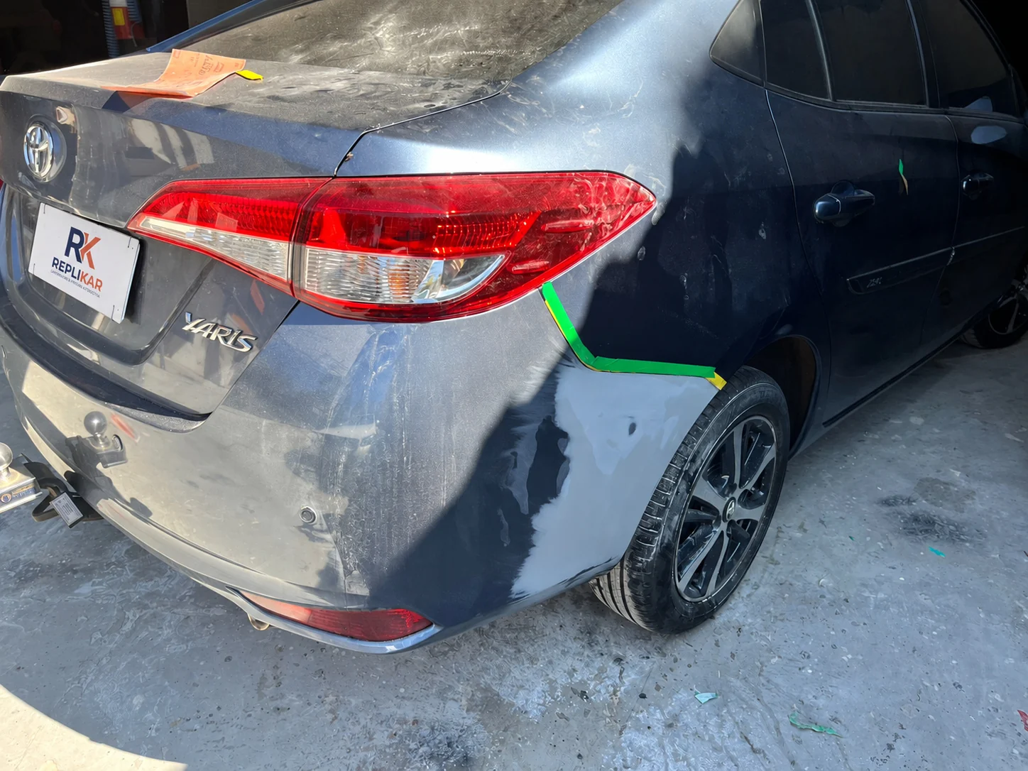 Toyota Yaris com massa aplicada na lateral traseira, em preparação para a pintura na Replikar